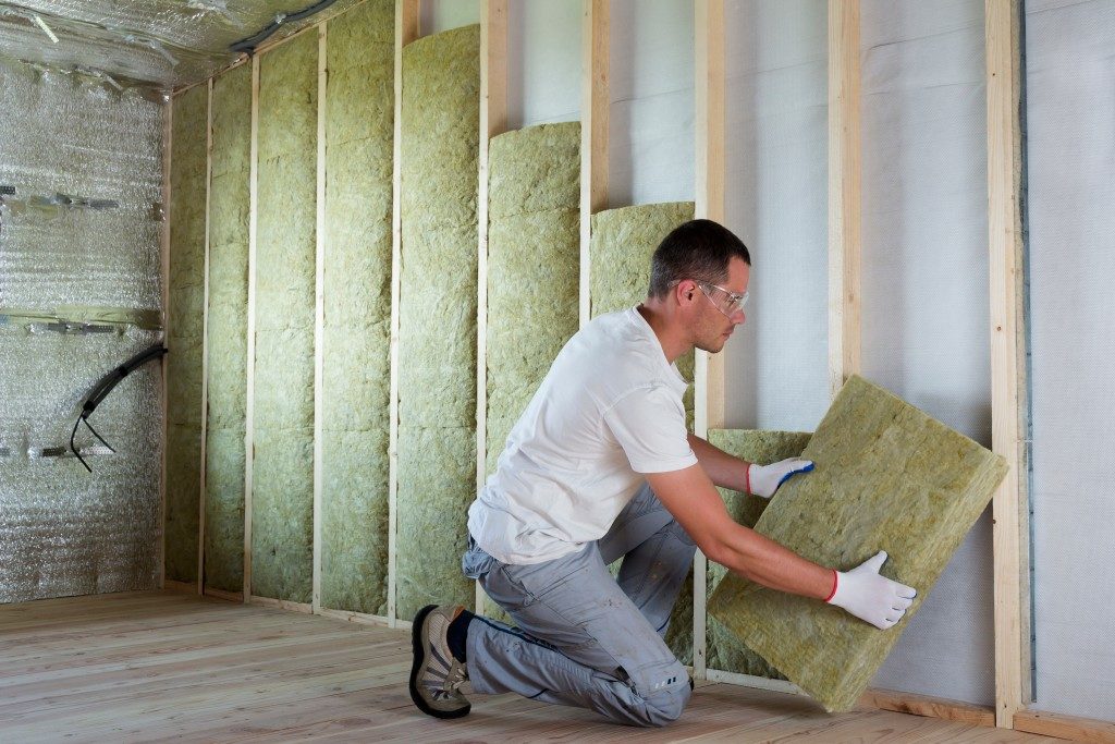 Man installing soundproof wall