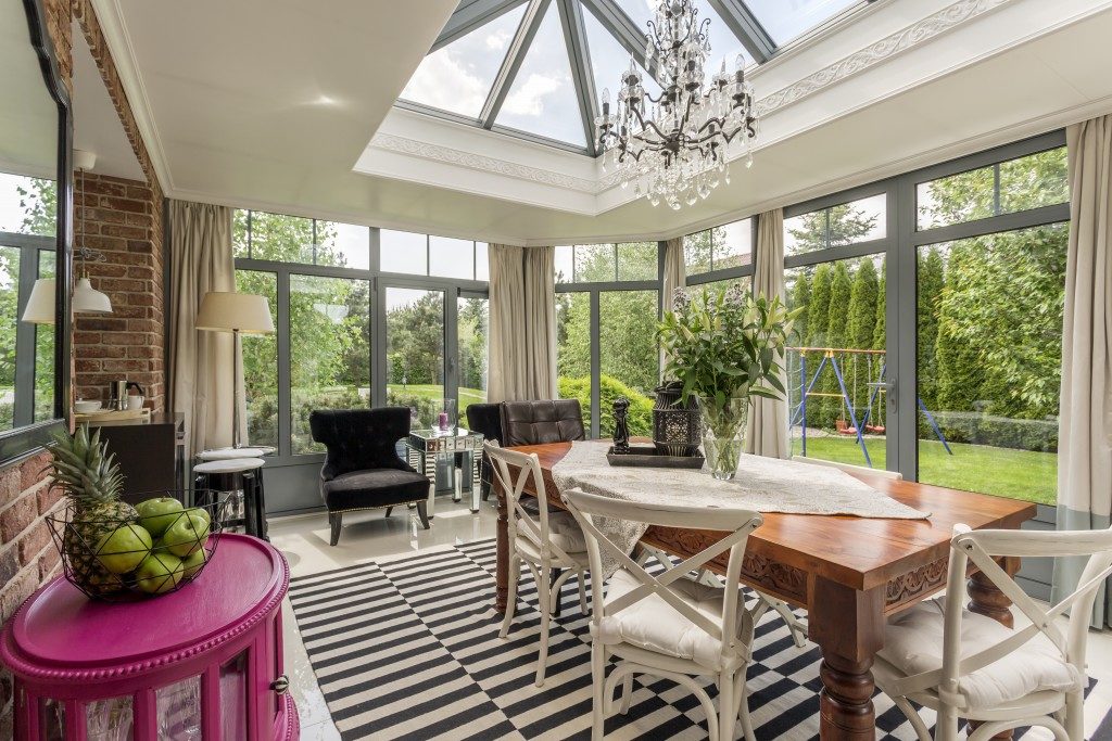 dining area with glass windows and sunroom glass ceiling
