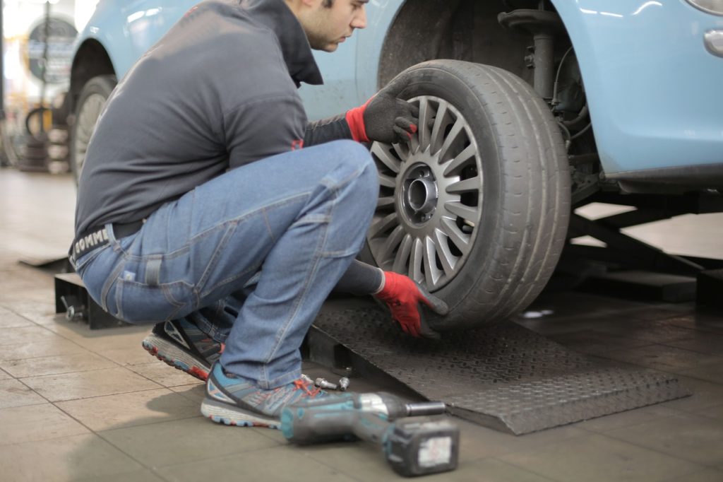 person replacing car tire