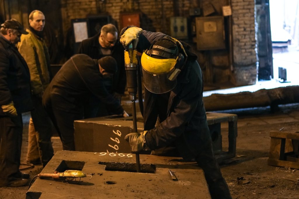 man drilling into a concrete block