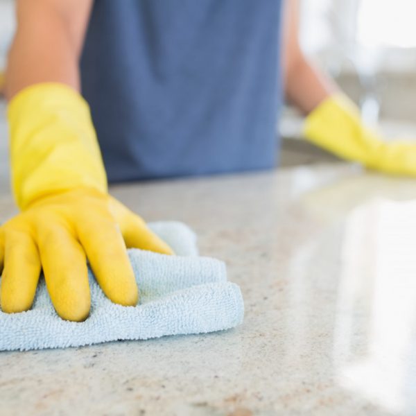a person cleaning a home counter
