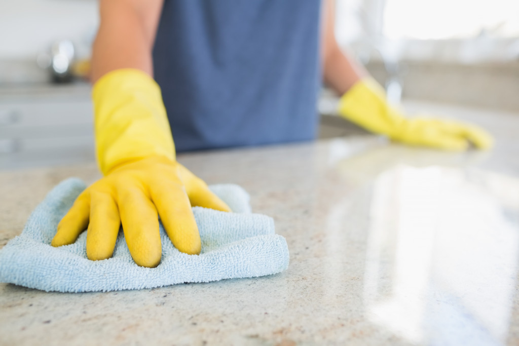 a person cleaning a home counter