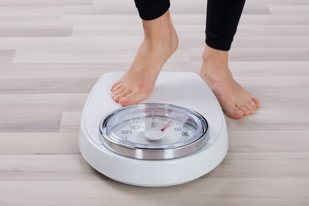 person standing on weighing scale