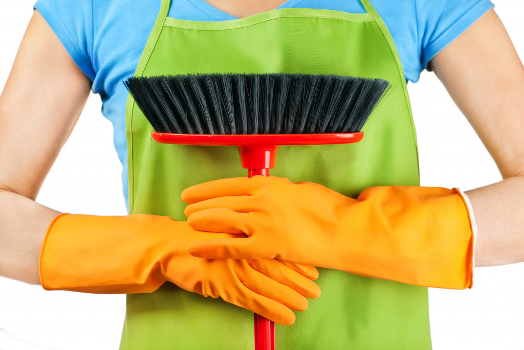 a person holding a scrubber for cleaning