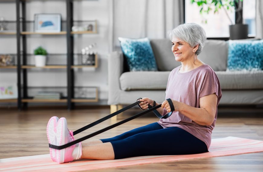 senior woman exercising with resistance band at home